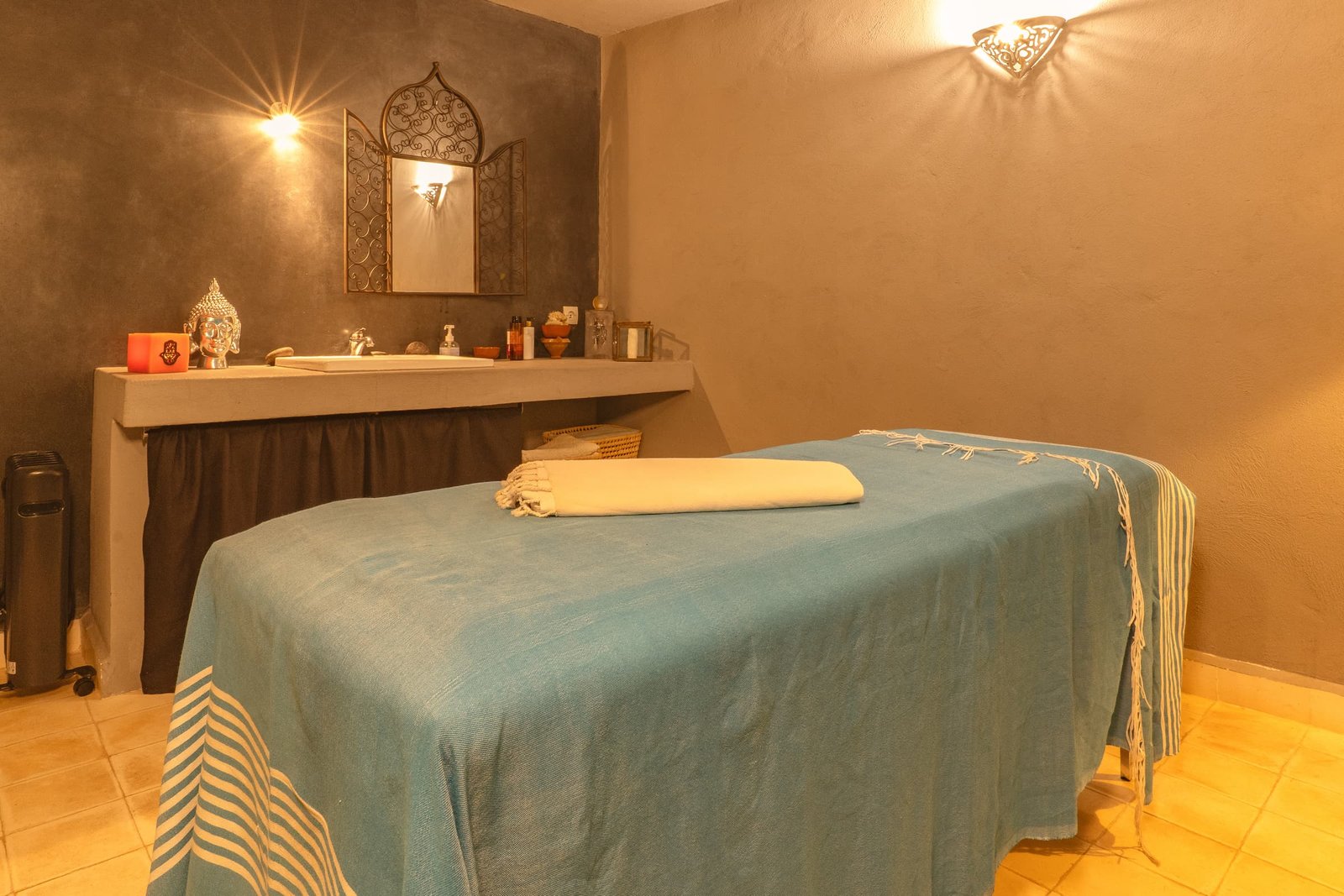 La table de massage et son miroir ciselé, dans la lumière tamisée du hammam