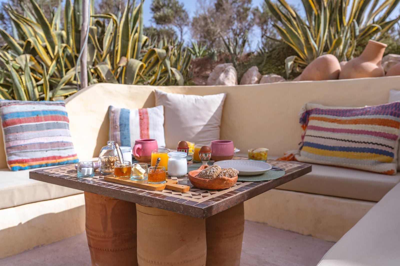 Breakfast served in the garden, juice, preserves and a teapot on the low table